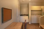 There is a large washer and dryer as well as a laptop friendly workspace on the lower level